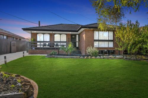 a house with a green lawn in front of it at Newly Renovated House near Melbourne Airport in Melbourne