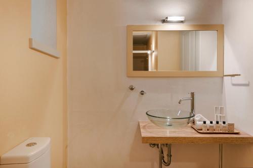 a bathroom with a sink and a mirror at Hydra Hotel in Hydra