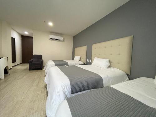 A bed or beds in a room at Hotel HR AMADA Cúcuta