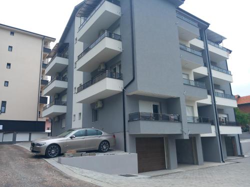 a car parked in front of a building at Apartman Soko 2 in Soko Banja