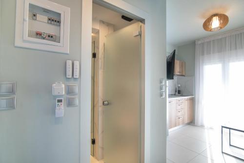 a hallway with a door leading to a kitchen at Olea Apartments Palioura Epanomi in Epanomi