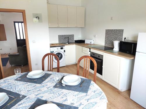 a kitchen with a table and chairs and a kitchen with a stove at Casa Alegria - Apartment Vista da Serra in Tomar