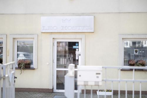 a white building with a la hostel sign on it at Leo Hostel in Poznań