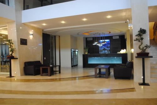 a lobby with chairs and a large aquarium in a building at Grand Hotel Napoca in Cluj-Napoca