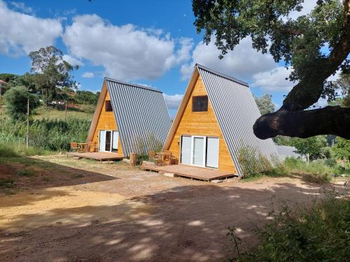 a house with a metal roof and white doors at FALCOARIA de Santa Efigenia in Setúbal