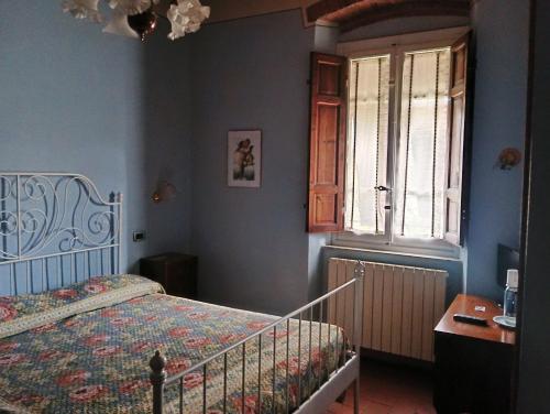 a bedroom with a bed and a window at Angelini in Lucca