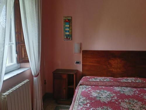 a small bedroom with a bed and a window at Angelini in Lucca