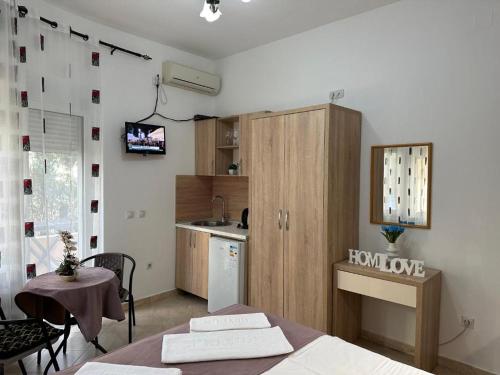 a room with a kitchen with a table and a kitchen at Apartments Sija in Ulcinj