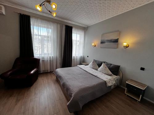 een hotelkamer met een bed en een stoel bij Saules rati in Daugavpils