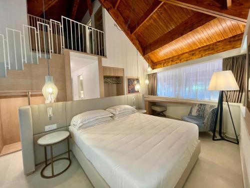 A bed or beds in a room at La Bussola Beach Hotel