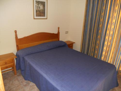 A bed or beds in a room at Apartamentos Palas Salou