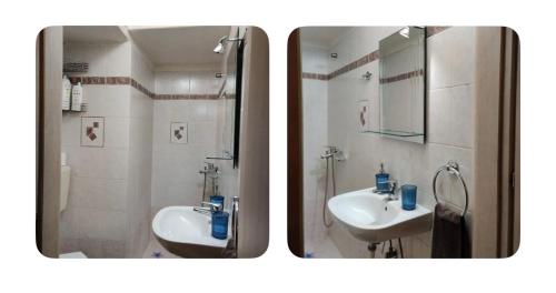 a bathroom with two sinks and a shower and a mirror at Amalias - city oasis in Thessaloniki