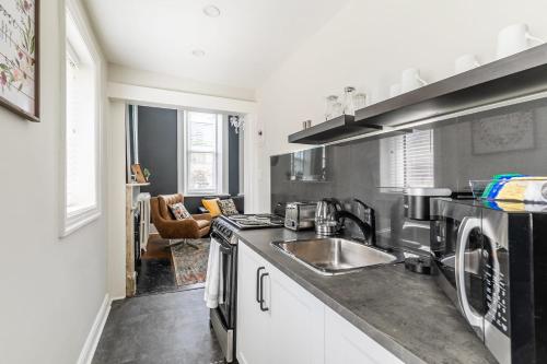 a kitchen with a sink and a stove at Apartment in the James South Neighborhood in Hamilton