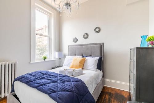 a bedroom with a bed with two towels on it at Apartment in the James South Neighborhood in Hamilton