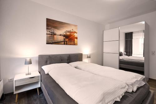 A bed or beds in a room at Harbour Prime Apartment Ettlingen Rheinstraße 40