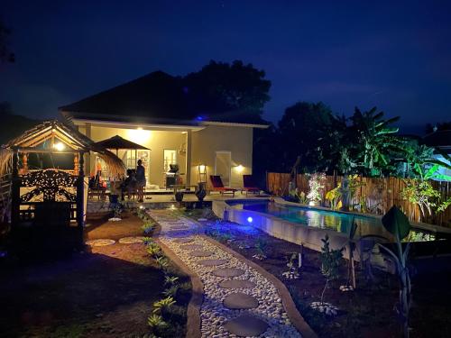 a house with a swimming pool at night at Villa NiMo Jimbaran in Jimbaran