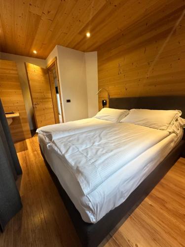 A bed or beds in a room at Alpen Hotel Chalet