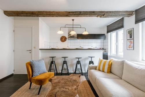 a living room with a couch and a table at Chic Cityscape Apartment Ghent in Ghent