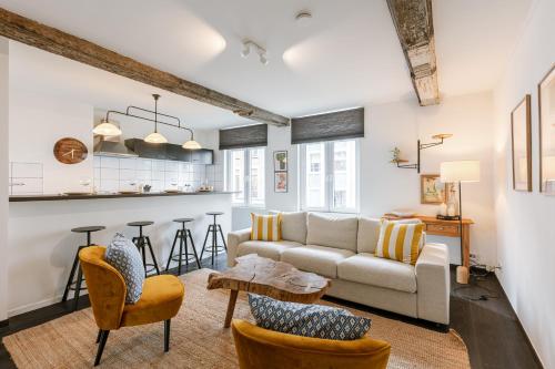 a living room with a couch and a table at Chic Cityscape Apartment Ghent in Ghent