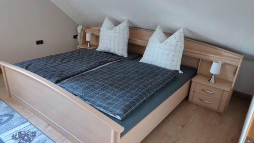 a bedroom with a bed with blue sheets and pillows at Ferienwohnung Hammerwaldblick in Selb