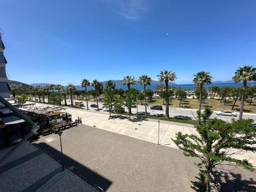 a view of a parking lot with palm trees at Luxury Sea View Apartment in Vlorë