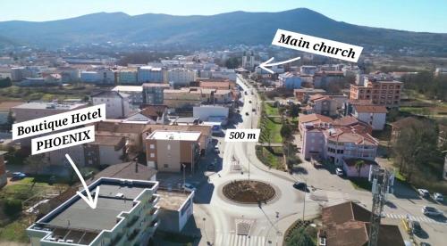 an aerial view of a city with buildings and mountains at Boutique Hotel PHOENIX Međugorje in Međugorje