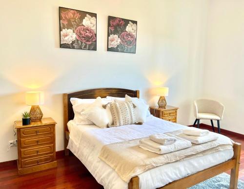 a bedroom with a bed with two night stands and two lamps at Villa Garden Santana by Your Key in Santana