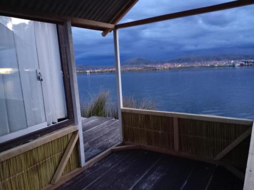 a balcony with a view of the water at Q'OTA TAYPY LODGE in Puno