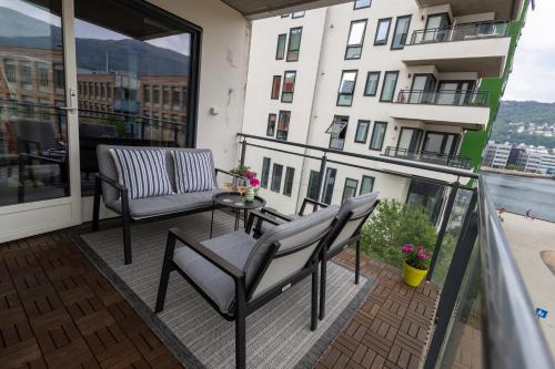 - Balcón con sillas y mesa en un edificio en Modern Apartment - Amazing Terrace and Fjord View, Close to City Center, en Bergen