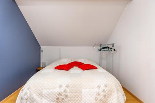 a bedroom with a bed with red pillows on it at Claire de Meuse Cozy apartment Detox with river and hills in Anhée