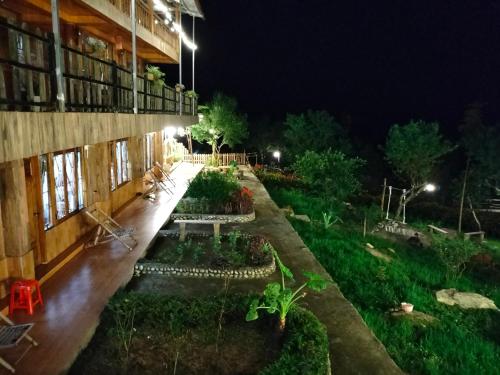 a courtyard of a building with a garden at night at Muong Hoa Hmong Homestay in Sa Pa