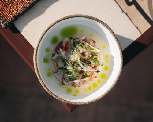 a bowl of food sitting on a table at Bratsera Boutique Hotel in Hydra