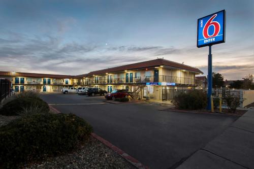 a hotel with a sign in a parking lot at Motel 6-Albuquerque, NM - Carlisle in Albuquerque