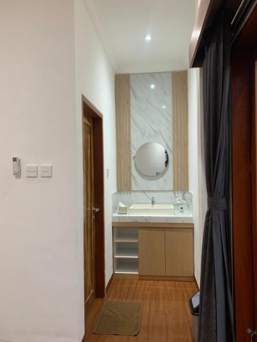 a bathroom with a sink and a mirror at Wikans Villa in Kuta