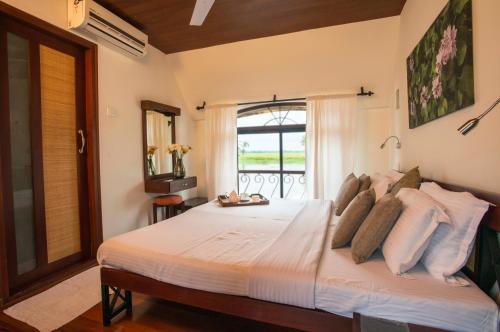 A bed or beds in a room at Xandari Riverscapes