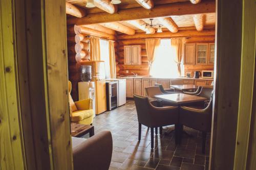 a kitchen with a table and chairs in a room at Vila Termal in Veľký Meder