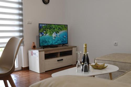 a living room with a flat screen tv on a table at KenDar Premium Apartments in Ulcinj