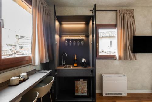 a kitchen with a counter and a sink and a window at Residenza Leutari in Rome