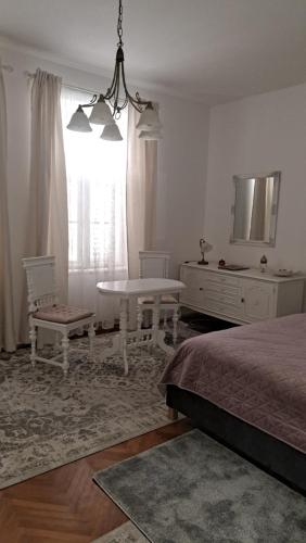 - une chambre avec un lit, une table et un miroir dans l'établissement Vintage Villa Magnolia, à Pula