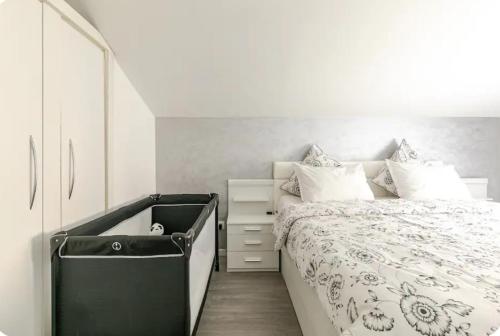 een slaapkamer met een bed en een dressoir ernaast bij Maisonnette avec terrasse in Straatsburg