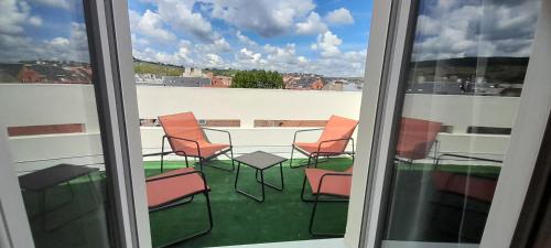 a view of a balcony with a table and chairs at Hotel de Champagne in Épernay