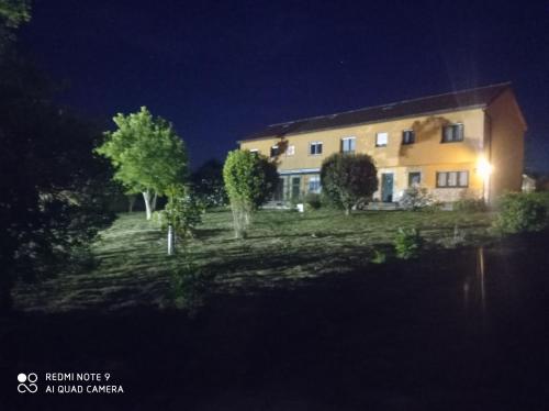 a house at night with a pond in front of it at En el camino in Santiso