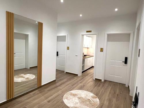 a room with a mirror and a hallway with white walls at Vila Beqja in Durrës