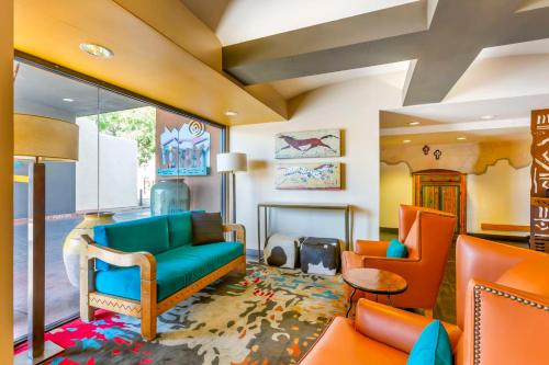 a living room with orange and blue furniture at Best Western Plus Rio Grande Inn in Albuquerque