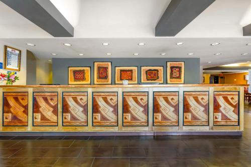 a lobby with a counter with paintings on it at Best Western Plus Rio Grande Inn in Albuquerque