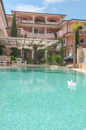 a paper boat in the water in front of a building at Casa Selimi in Ulcinj