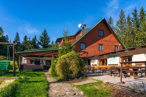 ein großes Holzhaus mit einem Picknicktisch in der Unterkunft Bačkárka - horská chata in Makov