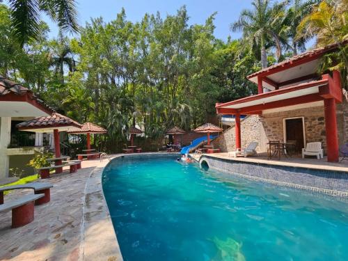 - une piscine avec toboggan dans un complexe dans l'établissement Rancho Agua Salada, à Alpuyeca