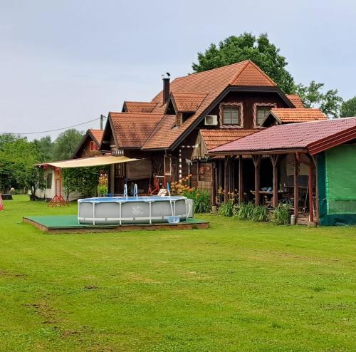 a large house with a hot tub in the yard at Rooms Ma La in Karlovac