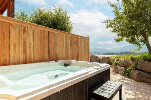 a jacuzzi tub with a wooden fence at Luxus-Appartement mit Whirlpool und Sauna #531 in Ainring